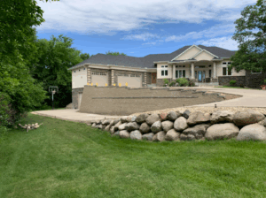 block retaining wall and a boulder retaining wall surrounding residential driveway